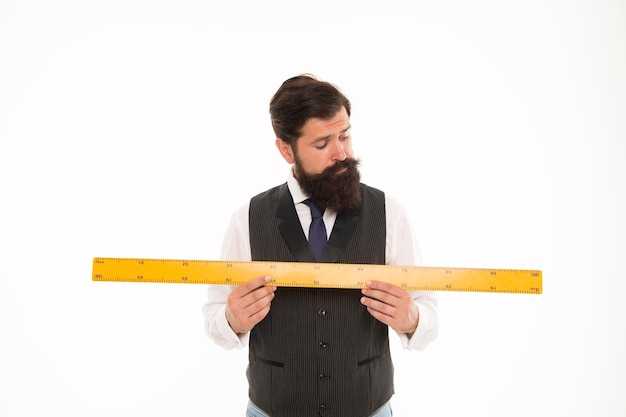 Size table concept Learning metric system School teacher Size really matters Man bearded hipster holding ruler Measure length Measure and control Geometry theorem Measure with centimeters