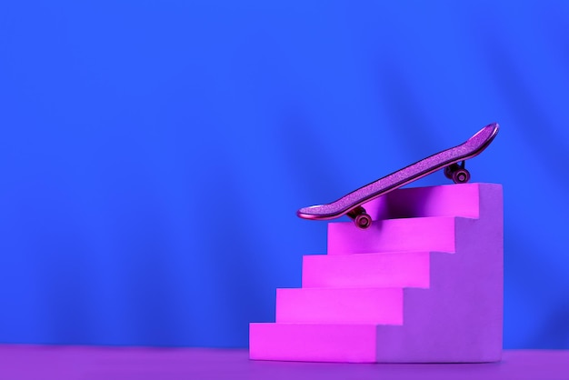 Skate in pink on the stairs as a symbol of extreme sports skateboarding parkour roller skates on a blue background with a place for text