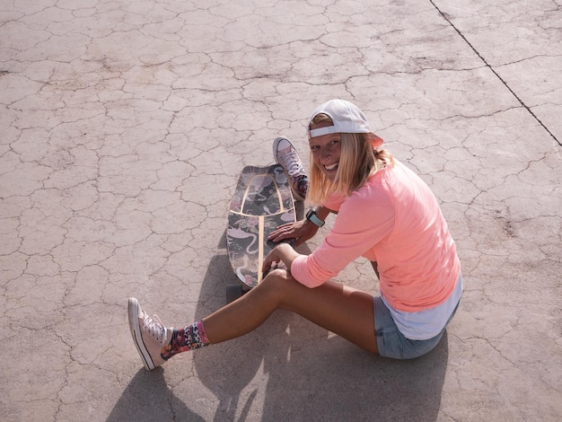 Skater woman on the floor after falling down