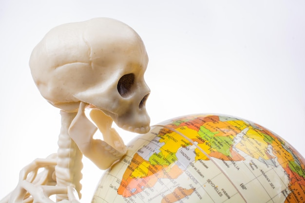 Skeleton with a globe in hands