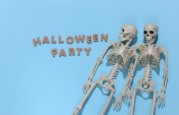 Skeletons on bright blue background with the word Halloween party. Halloween theme. 