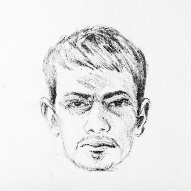 Sketch of male face drawing by hands with black pencil on white paper Closeup portrait of young guy