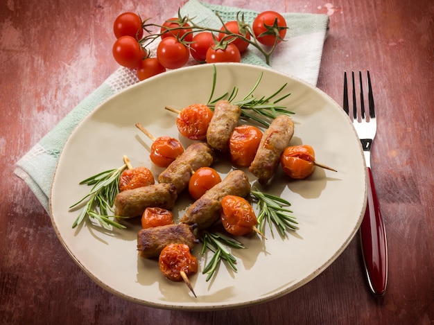 Skewer with sausage and cherry tomatoes