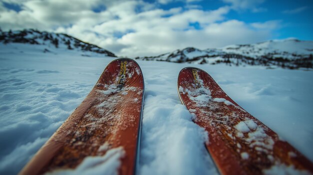 Photo ski equipment resting in fresh snow on a mountain landscape capturing the beauty of winter outdoors during a clear day