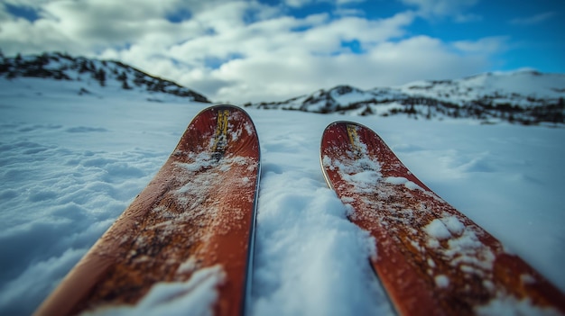 Photo ski equipment resting in fresh snow on a mountain landscape capturing the beauty of winter outdoors during a clear day