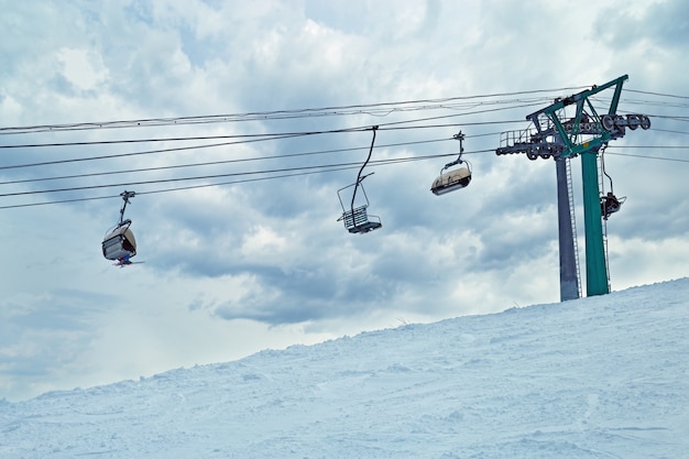 Ski lift against sky. Sheregesh ski resort. Active winter holidays.