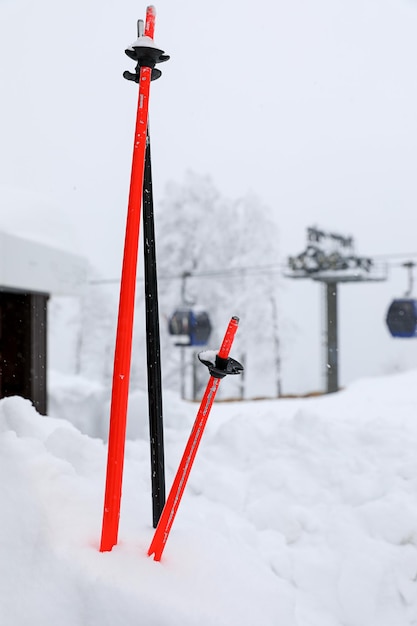 Ski poles sticking out of the snow on the ski slope. Concept winter sports, healthy lifestyle