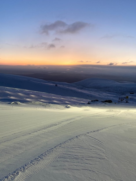 Ski resort at sunset Nothern winter landscape ski corduroy