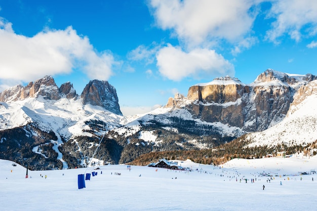 Ski slopes on ski resort in winter Dolomite Alps. Val Di Fassa, Italy. Winter holidays, travel destination