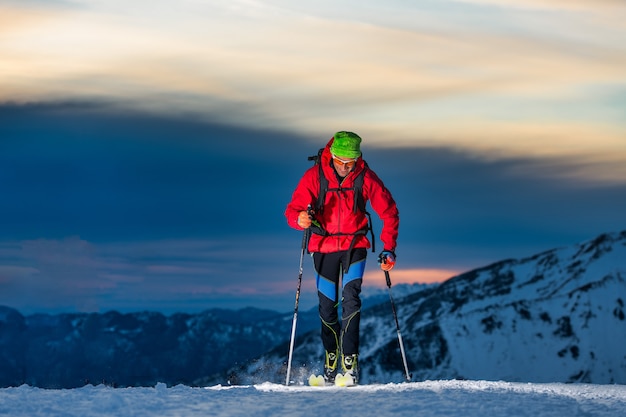 Ski touring at night in the last hours of the day