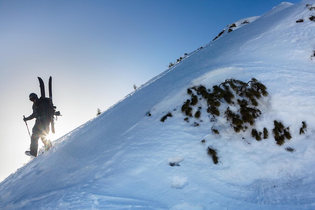 Ski tourist on a steep snow slope