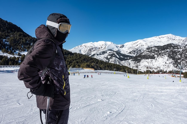 Skier next to the ski slopes ready to go down the slope Pyrenees Grandvalira Andorra