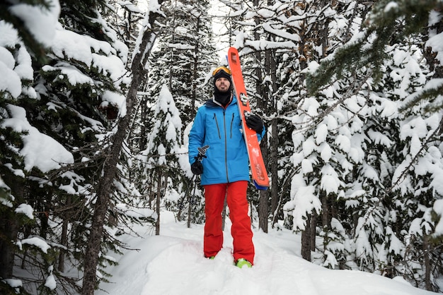 Skier walking on snow covered mountains