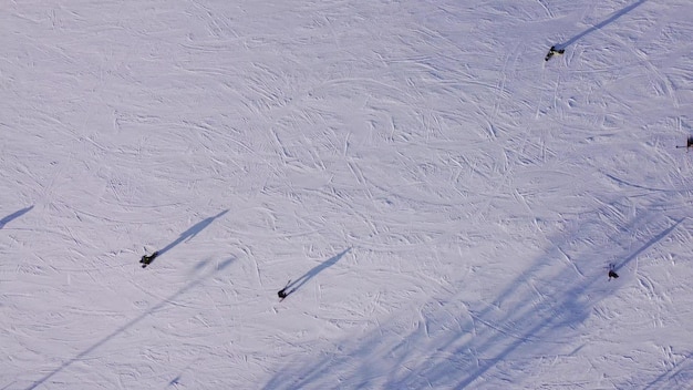 Skiers at mountain slope sunny day