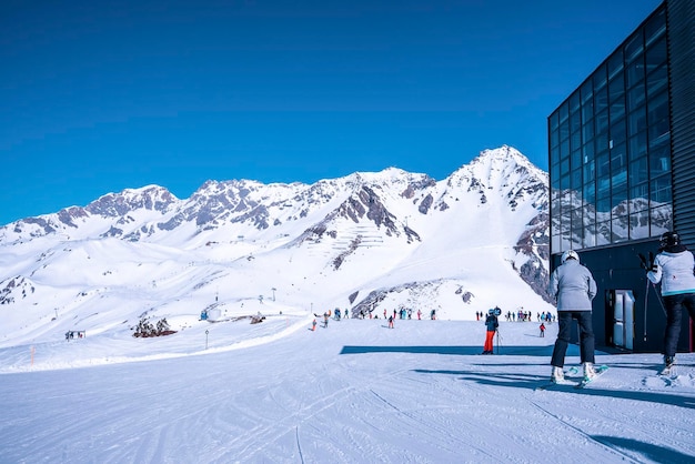 Skiers waiting at ski station on snow covered mountain