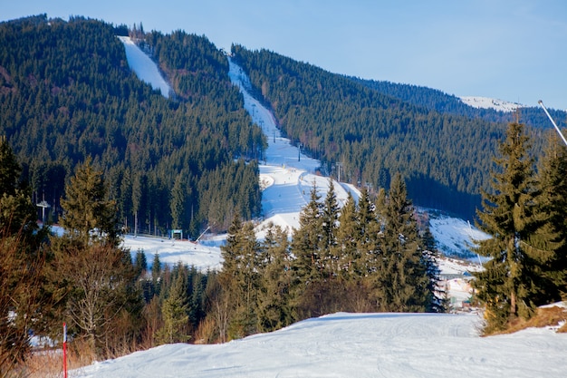 Skiing people and the chair lifts of ski region in Ukraine.