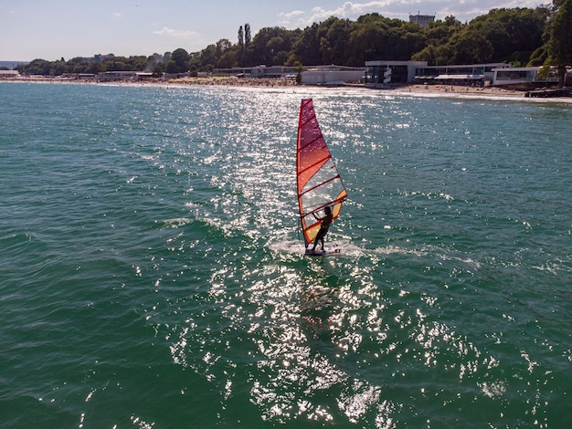 Skiing windsurfing in the sea at sunset