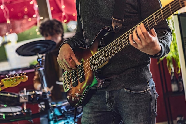 Skilled bassist playing closeup