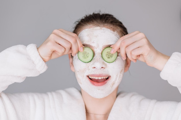 Skin care Beautiful girl with collagen mask and cucumber slices