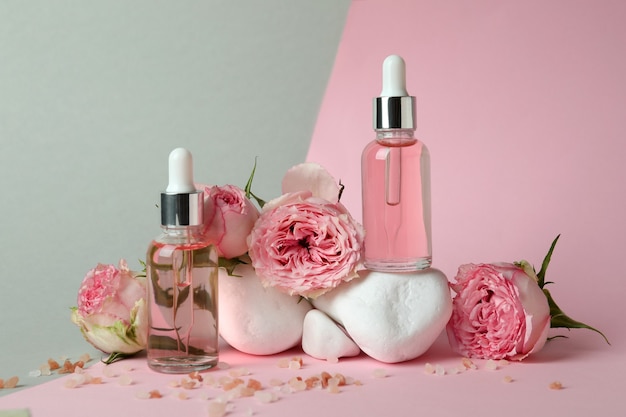 Skin care concept with essential rose oil on two tone