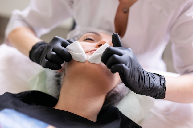 Skin care concept. A woman in a beauty salon during a facial skin care treatment.