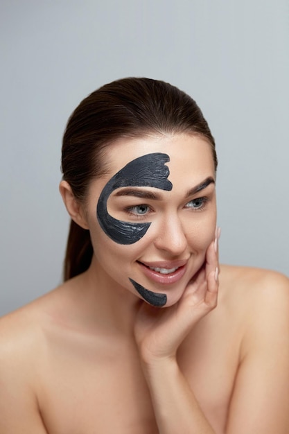 Skin care face black mask Beauty portrait of attractive girls with moisturizer mask