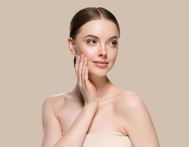 Skin care woman with hands portrait  skin closeup cosmetic age concept. Color background brown