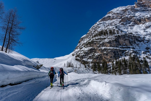 Skin skier in dolomites snow panorama