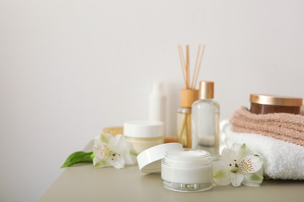 Skincare cream and flowers on the table cosmetics for skin care