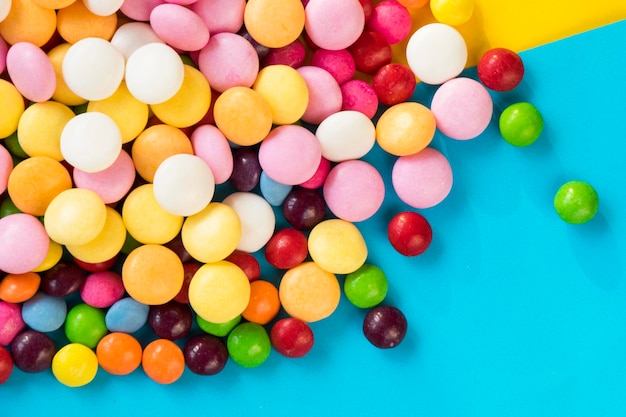 Skittles candy on the colorful table colorful sweet candy