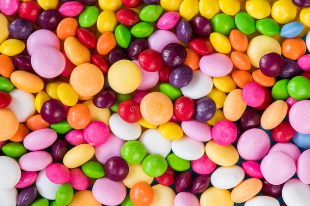 Skittles candy on the colorful table colorful sweet candy