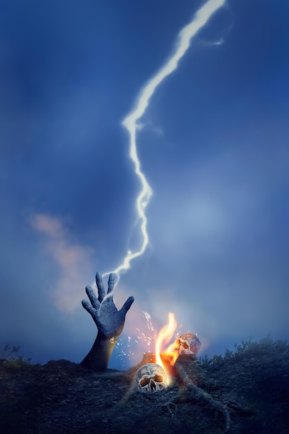 Skull hand lightning and fire in the cemetery at night Halloween image