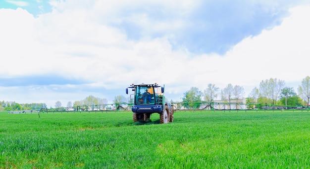 Skutec, Czech Republic, 17 May 2021: Pesticide spraying of young wheat in the field using a tractor sprayer.