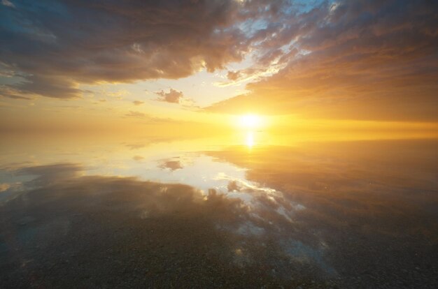 Sky background and sea water reflection on sunset