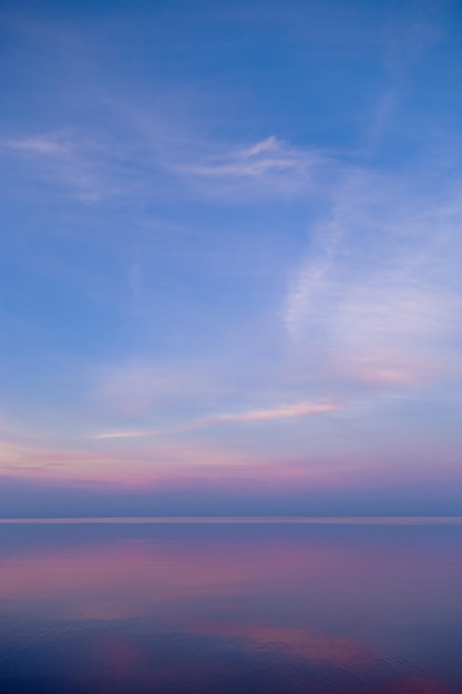 Sky background on sunset colorful clouds Nature abstract composition with reflections on sea water Nature environment