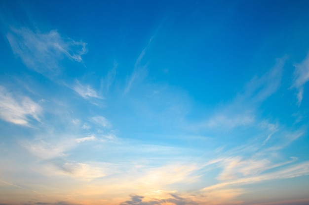 Sky blue and orange light of the sun through the clouds in the sky