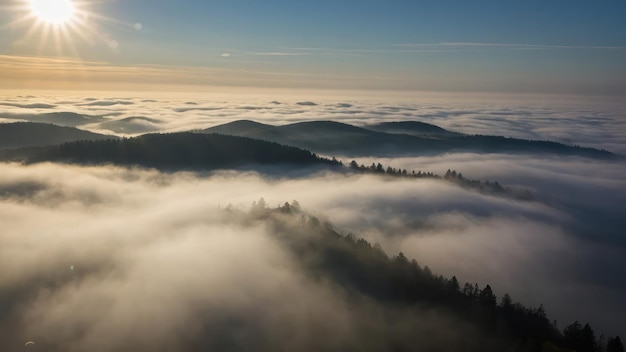 Sky covered in thick fog with the sun just barely visible over misty hills during sunrise