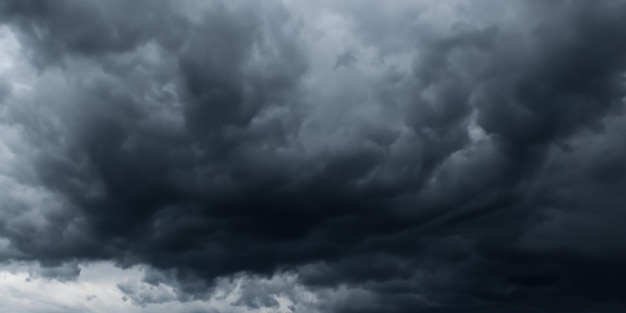 The sky darkens as black storm clouds gather ominously