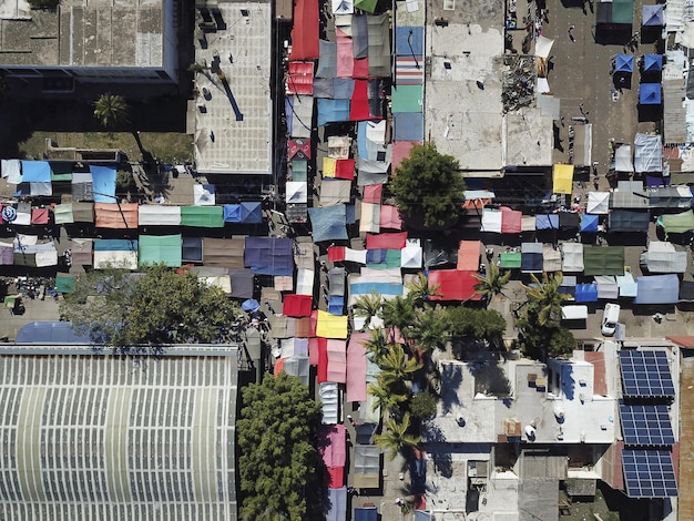 Sky drone view high angle shot of an open-air Sunday flea market in a poor city