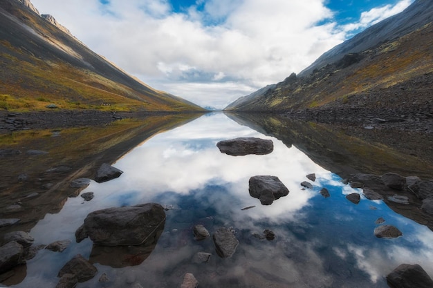 The sky is reflected in mountain lake of balance