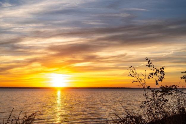 Sky at sunset twilight colors beautifully Natural background Seascape with beautiful sky in evening Sunset over calm sea View from above Panorama colorful magnificent sunset in lake