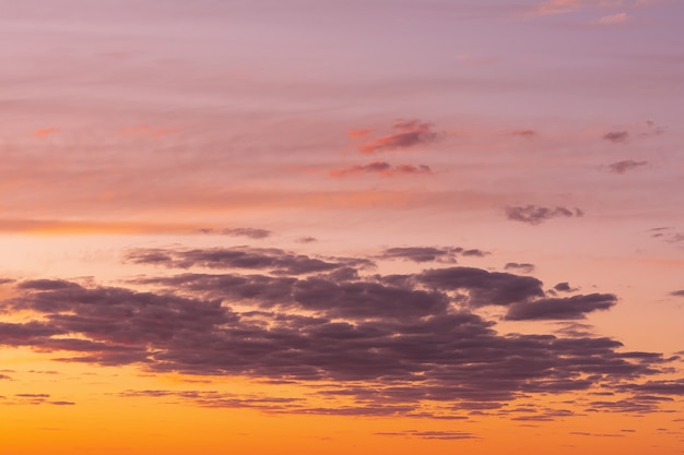 The sky at sunset with bright stains of orange and pink