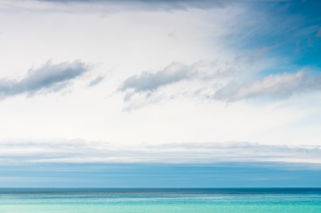 Sky with white and blue clouds over the blue sea Abstract summer nature background