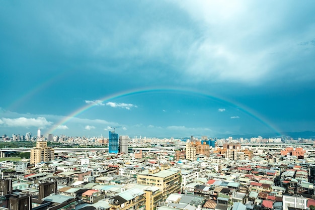 Skyline of taipei city in downtown Taipei Taiwanbright sun shining center top and a large rainbow