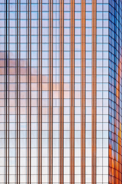 Skyscraper glass facades on a bright sunny day with sunbeams in the blue sky. Economy, finances, business activity concept. Bottom up view