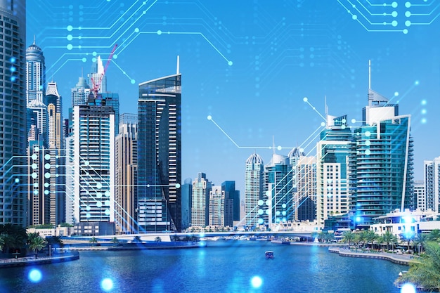 Skyscrapers of Dubai business downtown International hub of trading and financial services Technology theme icons hologram concept of big data Double exposure Dubai Canal waterfront