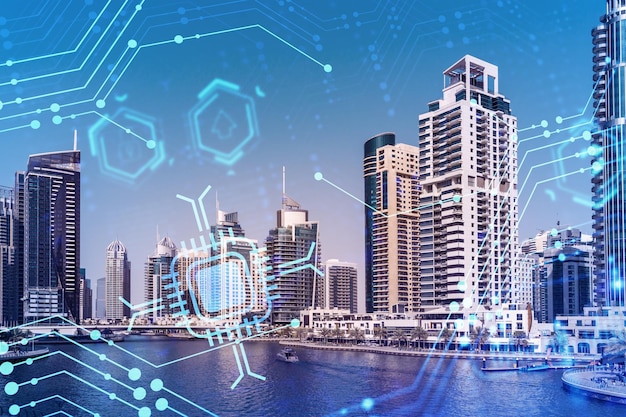 Skyscrapers of Dubai business downtown International hub of trading and financial services Technology theme icons hologram Fintech concept Double exposure Dubai Canal waterfront