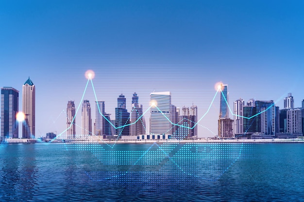 Skyscrapers of Dubai business downtown International hub of trading and financial services of Western Asia FOREX graph and chart concept Double exposure Dubai Canal waterfront