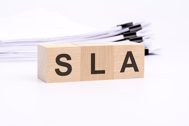 SLA letters on wooden cubes the background is a white business papers finance concept