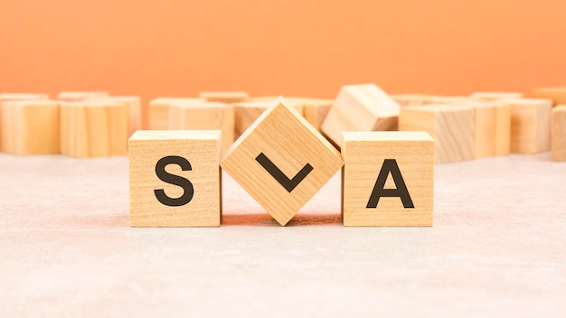 Sla wooden blocks word on orange background sla service level agreement information concept